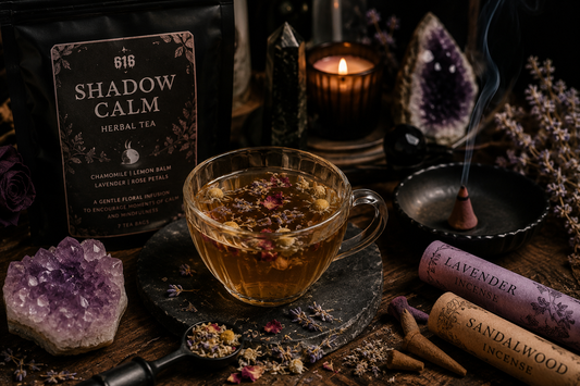 A glass cup of Shadow Calm herbal tea surrounded by chamomile, lemon balm, lavender, rose petals, amethyst crystal, lavender and sandalwood incense, creating a peaceful mindfulness ritual scene.
